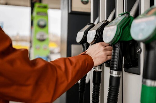 man-grabbing-fuel-pump-gas-600nw-2760215327